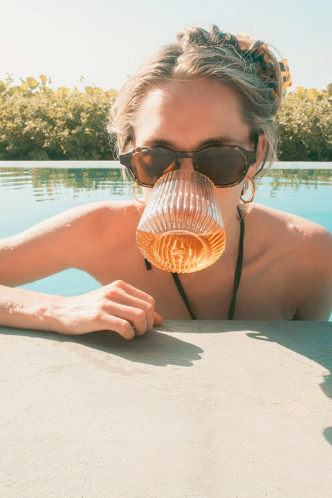 Biting the Djuce Studio Unbreakable Wine Glass in the pool